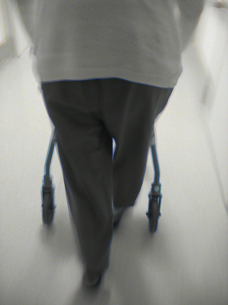 person pushing a walker from behind