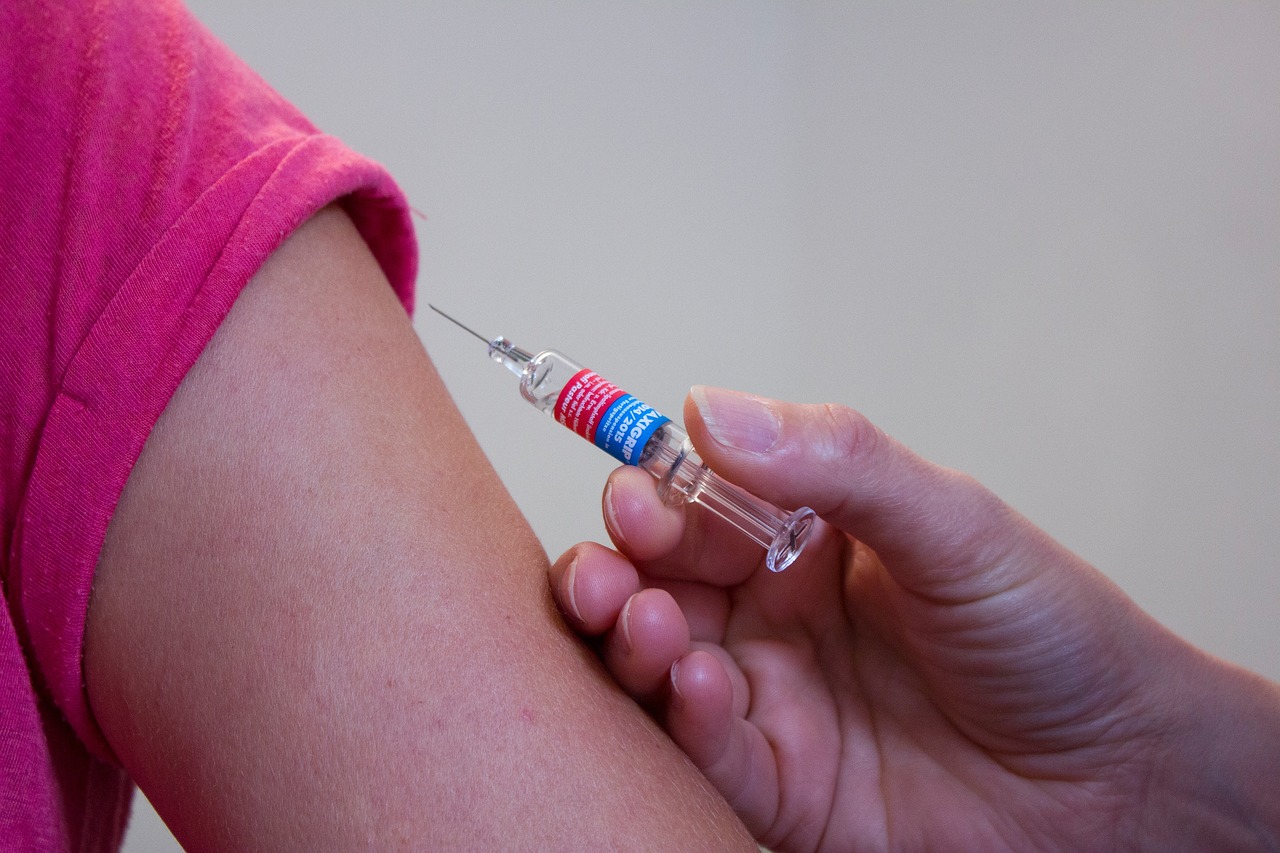 Individual receiving vaccine shot in arm