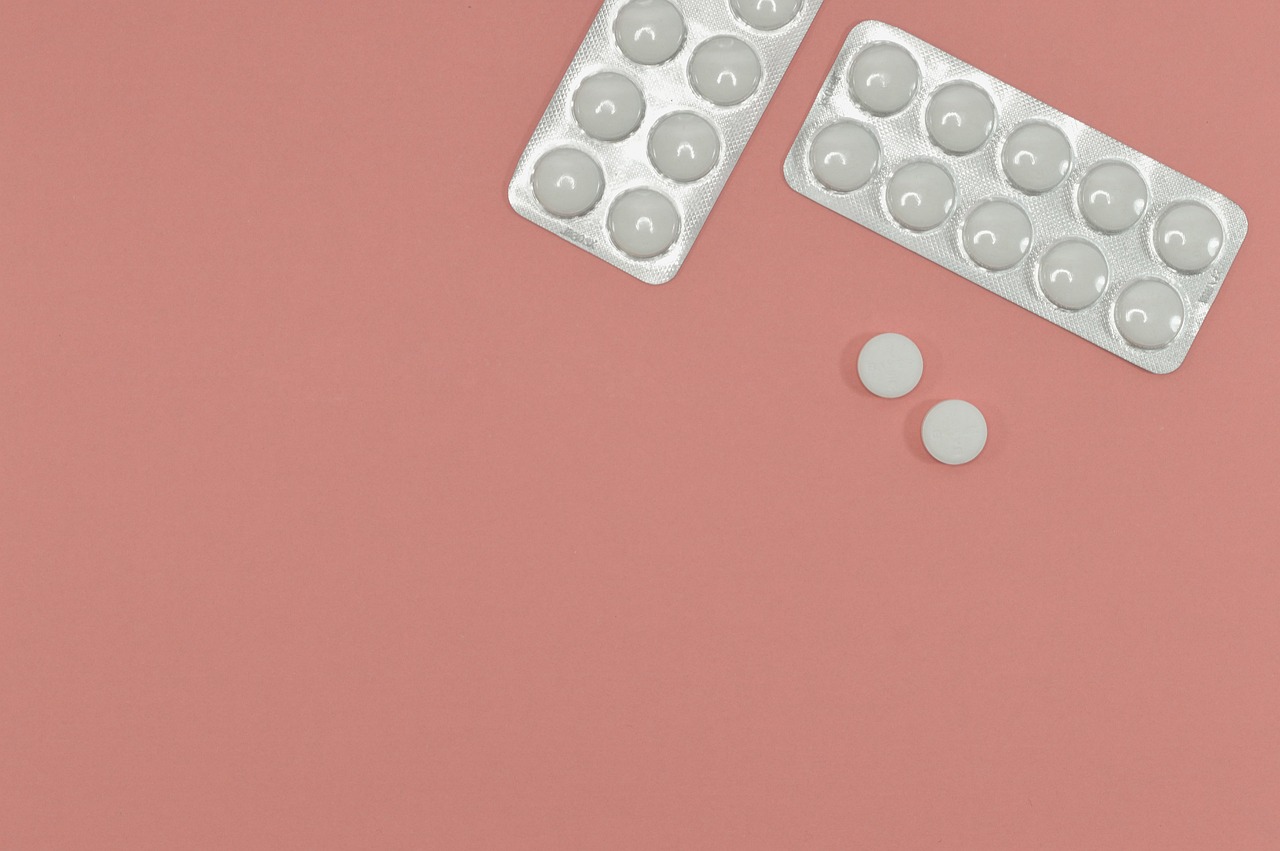 aspirin tablets on peach background